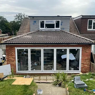 a back yard with a patio and a brick house